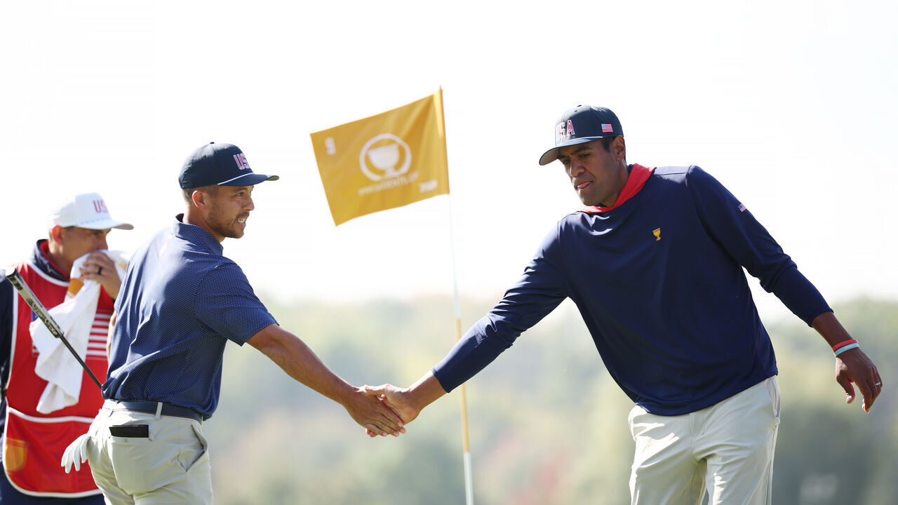 MONTREAL, QUEBEC - SEPTEMBER 28: Xander Schauffele (L) and Tony Finau of the U.S. Team celebrate on the ninth green during Saturday Morning Four-Ball on day three of the 2024 Presidents Cup at The Royal Montreal Golf Club on September 28, 2024 in Montreal, Quebec, Canada.
