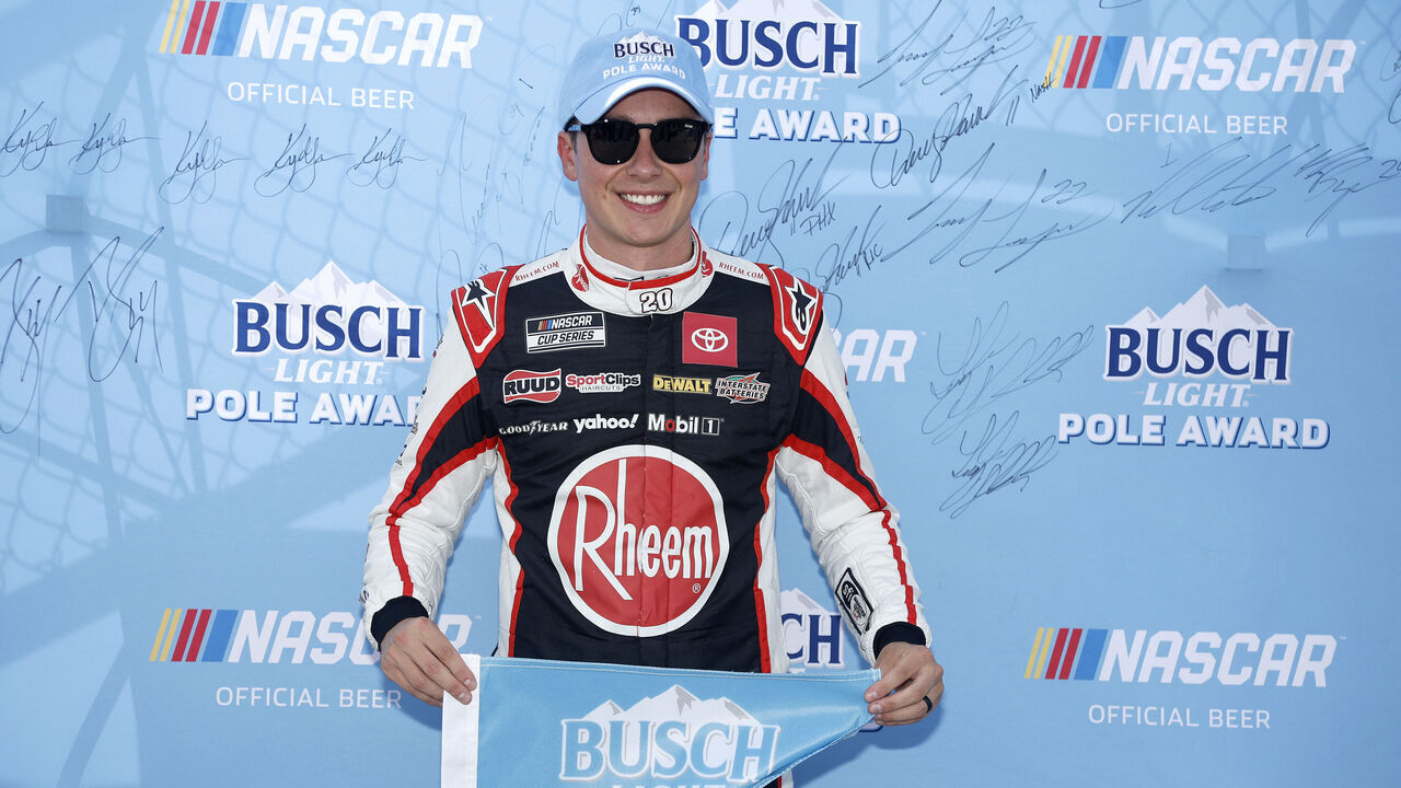KANSAS CITY, KANSAS - SEPTEMBER 28: Christopher Bell, driver of the #20 Rheem Toyota, poses for photos after winning the pole award during qualifying for the NASCAR Cup Series Hollywood Casino 400 Presented by ESPN BET at Kansas Speedway on September 28, 2024 in Kansas City, Kansas.