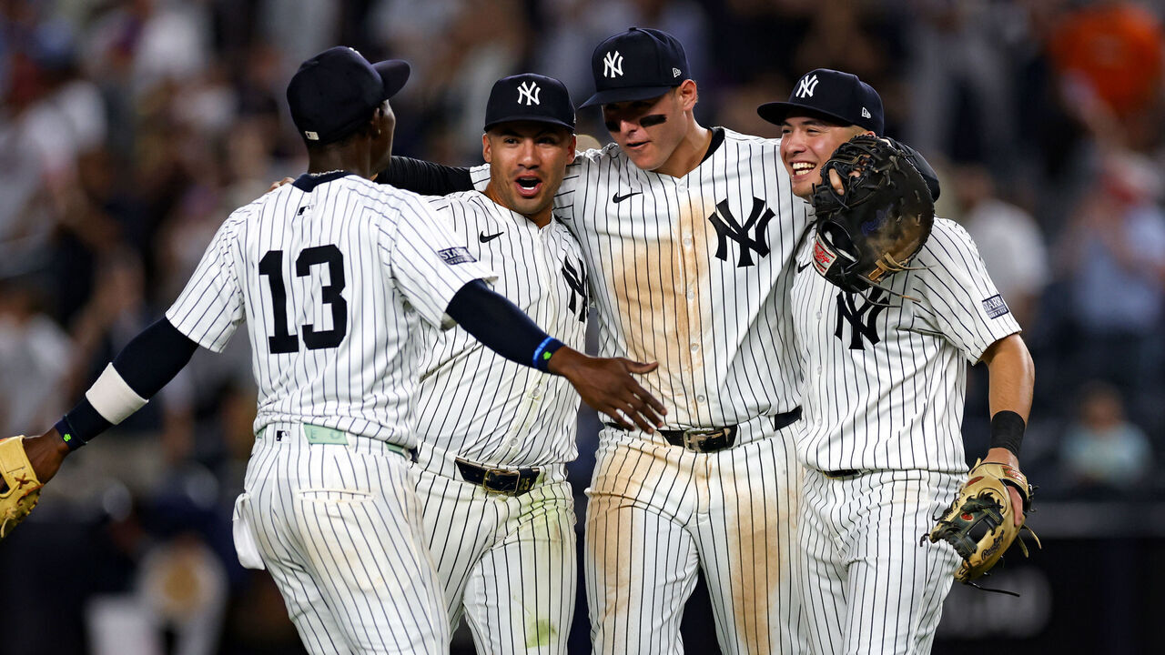 NEW YORK, NY - SEPTEMBER 26: Jazz Chisholm Jr. #13, Gleyber Torres #25, Anthony Rizzo #48 and Anthony Volpe #11 of the New York Yankees celebrate after clinching the AL East Division at Yankee Stadium on September 26, 2024, in New York, New York.