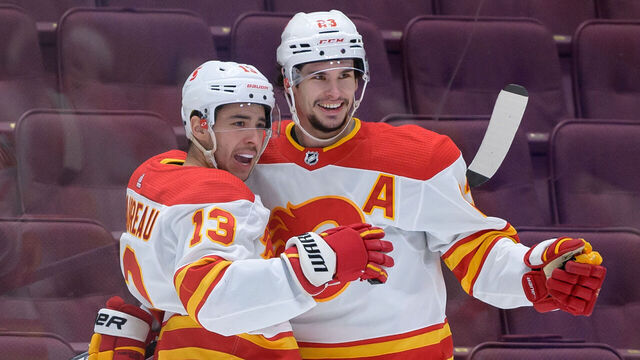 VANCOUVER, BC - FEBRUARY 11: Calgary Flames Left Wing Johnny Gaudreau (13) is congratulated by Center Sean Monahan (23) after scoring a goal against the Vancouver Canucks during their NHL game at Rogers Arena on February 11, 2021 in Vancouver, British Columbia, Canada.