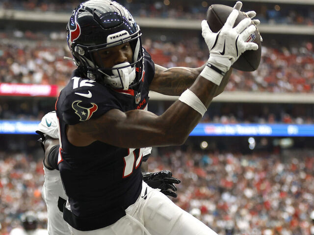 HOUSTON, TEXAS - SEPTEMBER 29: Nico Collins #12 of the Houston Texans attempts to catch a pass against the Jacksonville Jaguars during the first half at NRG Stadium on September 29, 2024 in Houston, Texas.