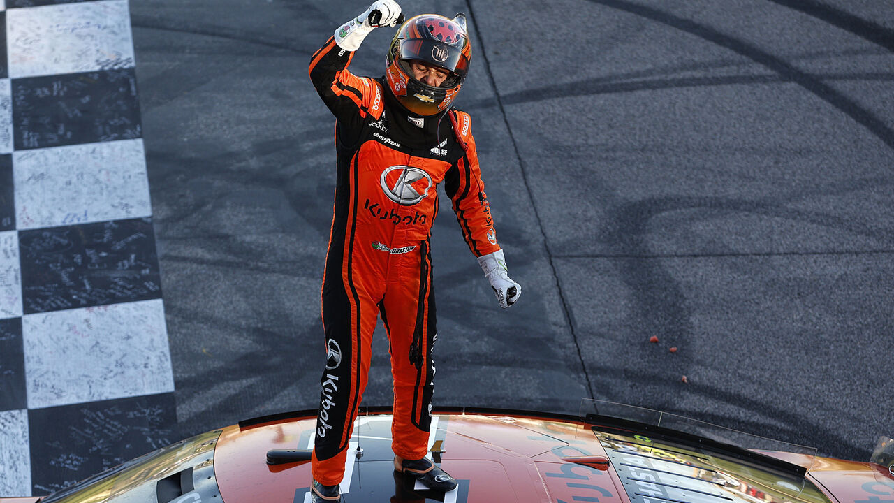 KANSAS CITY, KANSAS - SEPTEMBER 29: Ross Chastain, driver of the #1 Kubota Chevrolet, celebrates after winning the NASCAR Cup Series Hollywood Casino 400 Presented by ESPN BET at Kansas Speedway on September 29, 2024 in Kansas City, Kansas.
