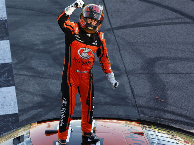 KANSAS CITY, KANSAS - SEPTEMBER 29: Ross Chastain, driver of the #1 Kubota Chevrolet, celebrates after winning the NASCAR Cup Series Hollywood Casino 400 Presented by ESPN BET at Kansas Speedway on September 29, 2024 in Kansas City, Kansas.
