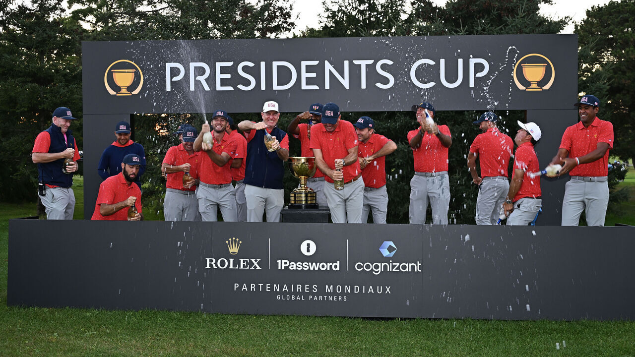 MONTREAL, QUEBEC - SEPTEMBER 29: U.S. Team players celebrate with the Presidents Cup Trophy after winning the 2024 Presidents Cup at The Royal Montreal Golf Club on September 29, 2024 in Montreal, Quebec..
