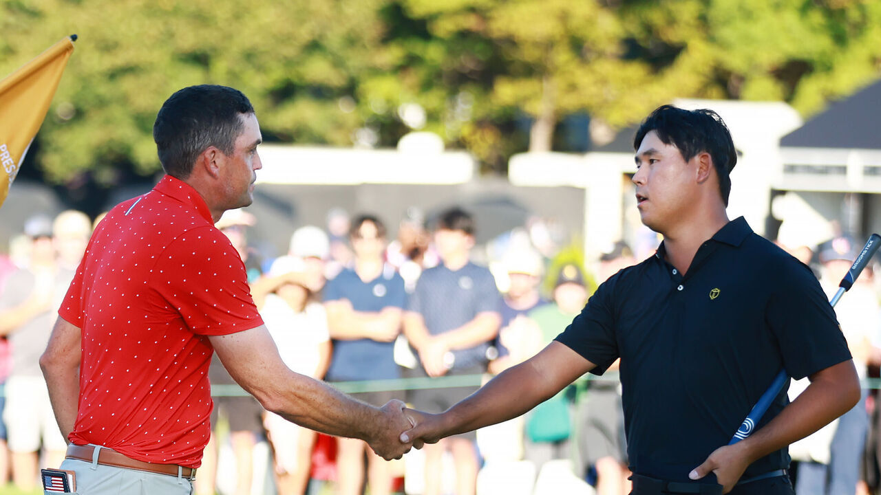 MONTREAL, QUEBEC - SEPTEMBER 29: Keegan Bradley of the U.S. Team shakes hands with Si Woo Kim of South Korea and the International Team after Bradley defeated Kim 1 UP during Sunday Singles on day four of the 2024 Presidents Cup at The Royal Montreal Golf Club on September 29, 2024 in Montreal, Quebec, Canada.