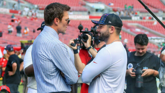 TAMPA, FL - SEPTEMBER 29: Former Tampa Bay Buccaneers Quarterback and Fox Commentator Tom Brady talks to Buccaneers Quarterback Baker Mayfield (6) before the game between the Philadelphia Eagles and the Tampa Bay Buccaneers on September 29, 2024 at Raymond James Stadium in Tampa, Florida.