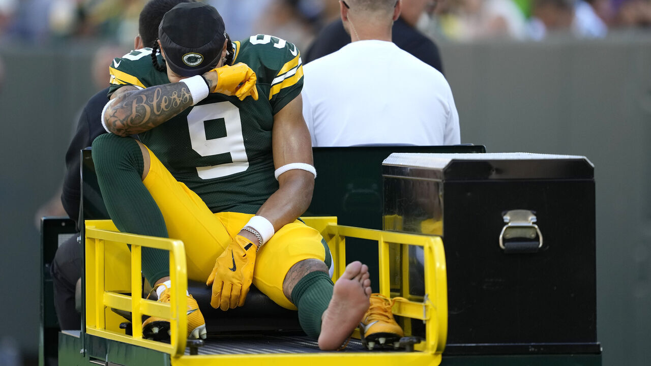 GREEN BAY, WISCONSIN - SEPTEMBER 29: Christian Watson #9 of the Green Bay Packers is carted off the field after an apparent injury during the first half of the game against the Minnesota Vikings at Lambeau Field on September 29, 2024 in Green Bay, Wisconsin.