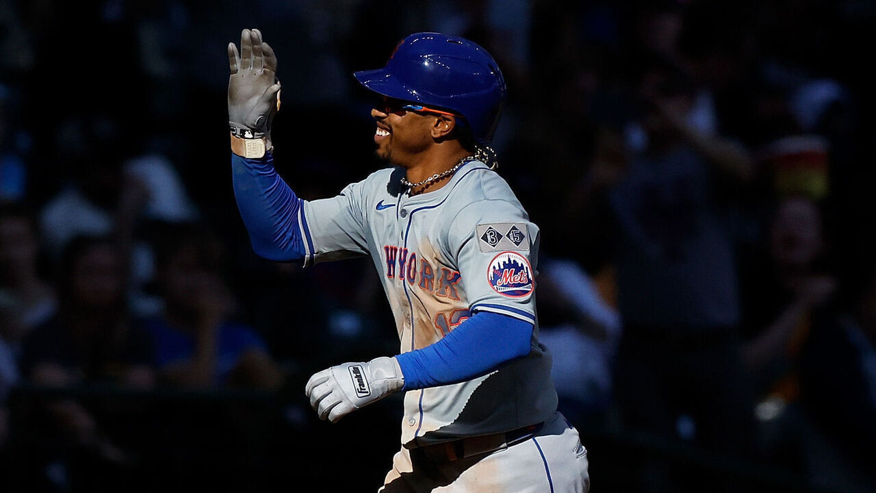 MILWAUKEE, WISCONSIN - SEPTEMBER 29: Francisco Lindor #12 of the New York Mets is congratulated by third base coach Mike Sarbaugh #86 of the New York Mets after hitting a solo home run in the sixth inning against the Milwaukee Brewers at American Family Field on September 29, 2024 in Milwaukee, Wisconsin.