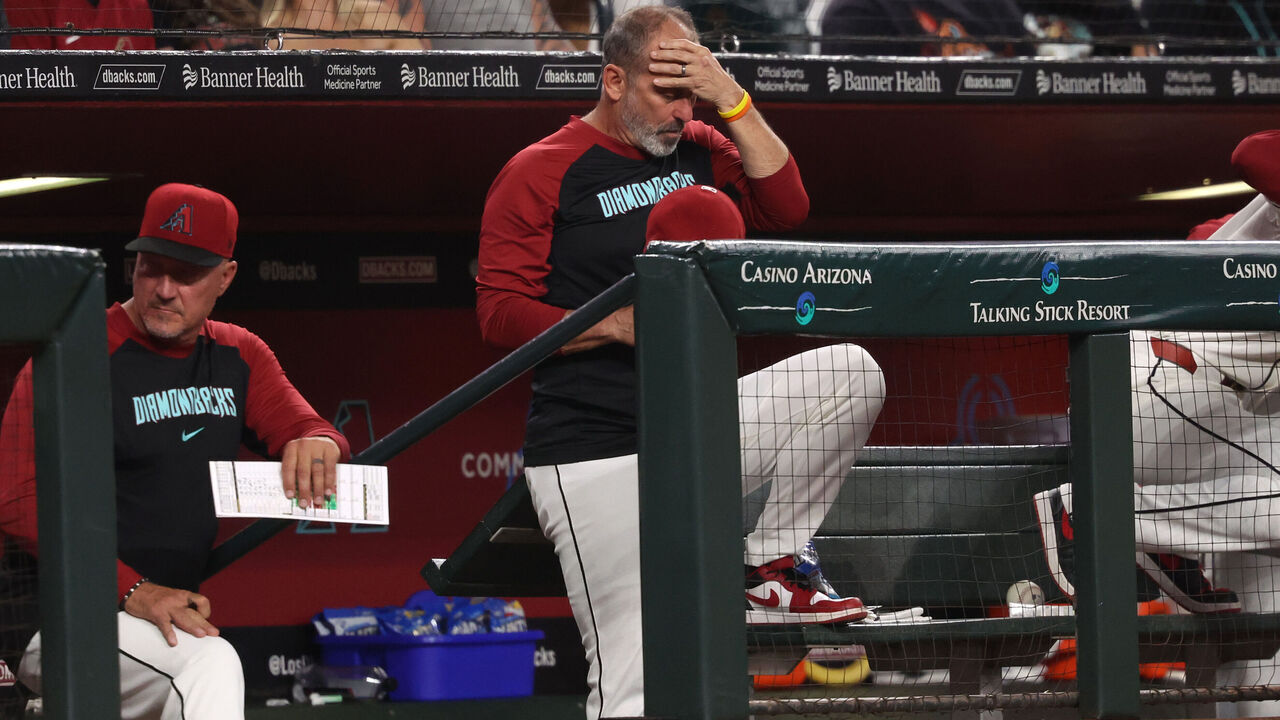 PHOENIX, ARIZONA - SEPTEMBER 27: Manager Torey Lovullo #17 of the Arizona Diamondbacks rubs his head during the fifth inning against the San Diego Padres at Chase Field on September 27, 2024 in Phoenix, Arizona.