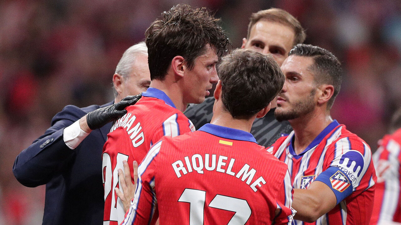 MADRID, SPAIN - SEPTEMBER 29: Robin Le Normand (L) of Atletico de Madrid is assisted by his teammates Koke (R), Rodrigo Riquelme (2ndR) and medical staff after clashing with Aurelien Tchouameni (not in the picture) of Real Madrid CF during the LaLiga match between Atletico de Madrid and Real Madrid CF at Estadio Civitas Metropolitano on September 29, 2024 in Madrid, Spain.