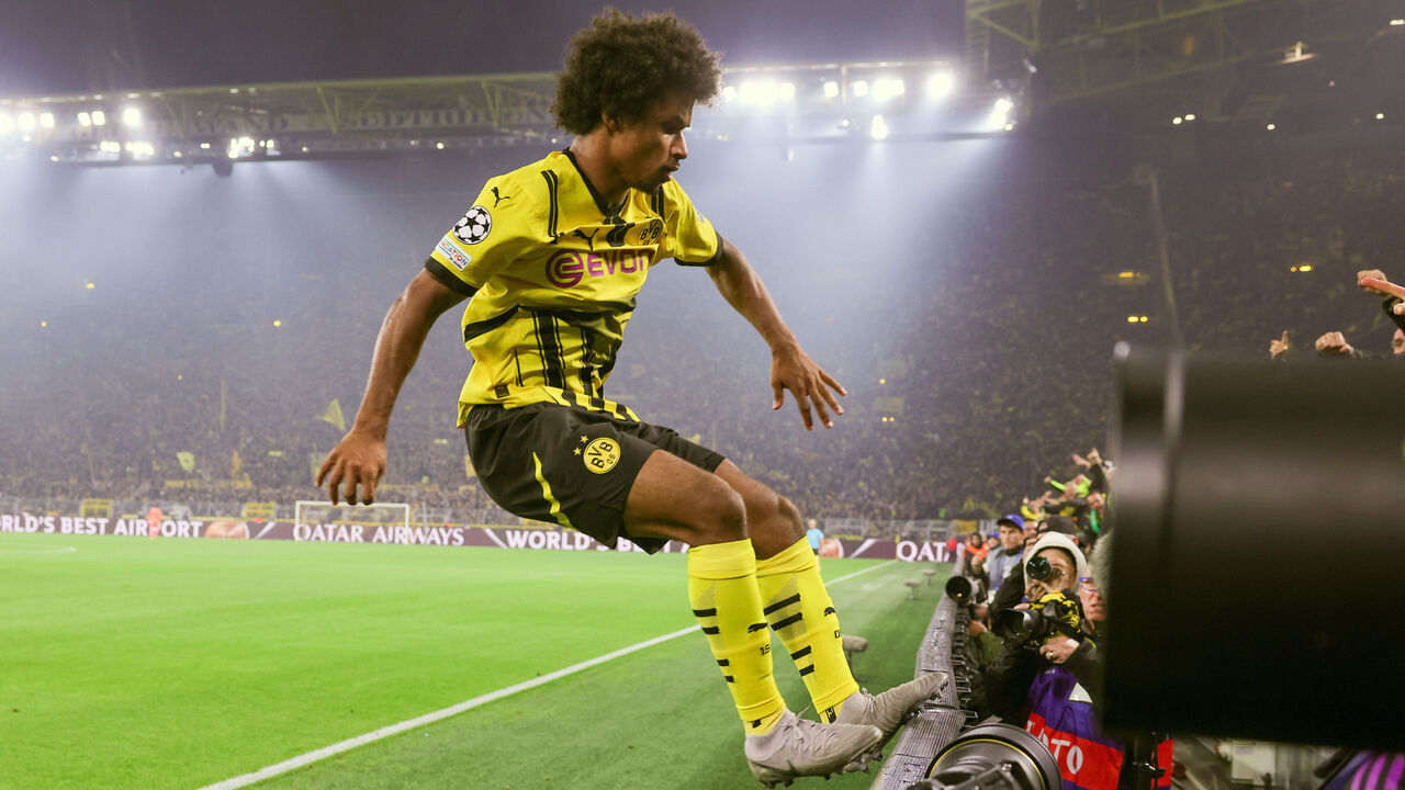 DORTMUND, GERMANY - OCTOBER 1: Karim Adeyemi of Borussia Dortmund celebrates the teams second on advertising band during the UEFA Champions League 2024/25 League Phase MD6 match between Borussia Dortmund and FC Barcelona at BVB Stadion Dortmund on October 1, 2024 in Dortmund, Germany.