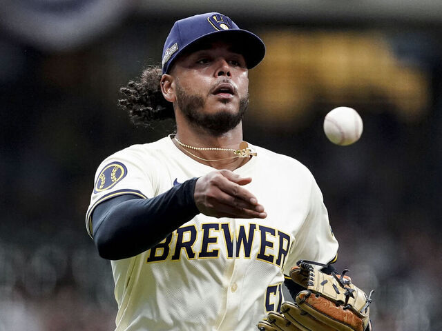 MILWAUKEE, WI - OCTOBER 01: Freddy Peralta #51 of the Milwaukee Brewers tosses to first base during Game 1 of the Wild Card Series presented by T-Mobile 5G Home Internet between the New York Mets and the Milwaukee Brewers at American Family Field on Tuesday, October 1, 2024 in Milwaukee, Wisconsin.