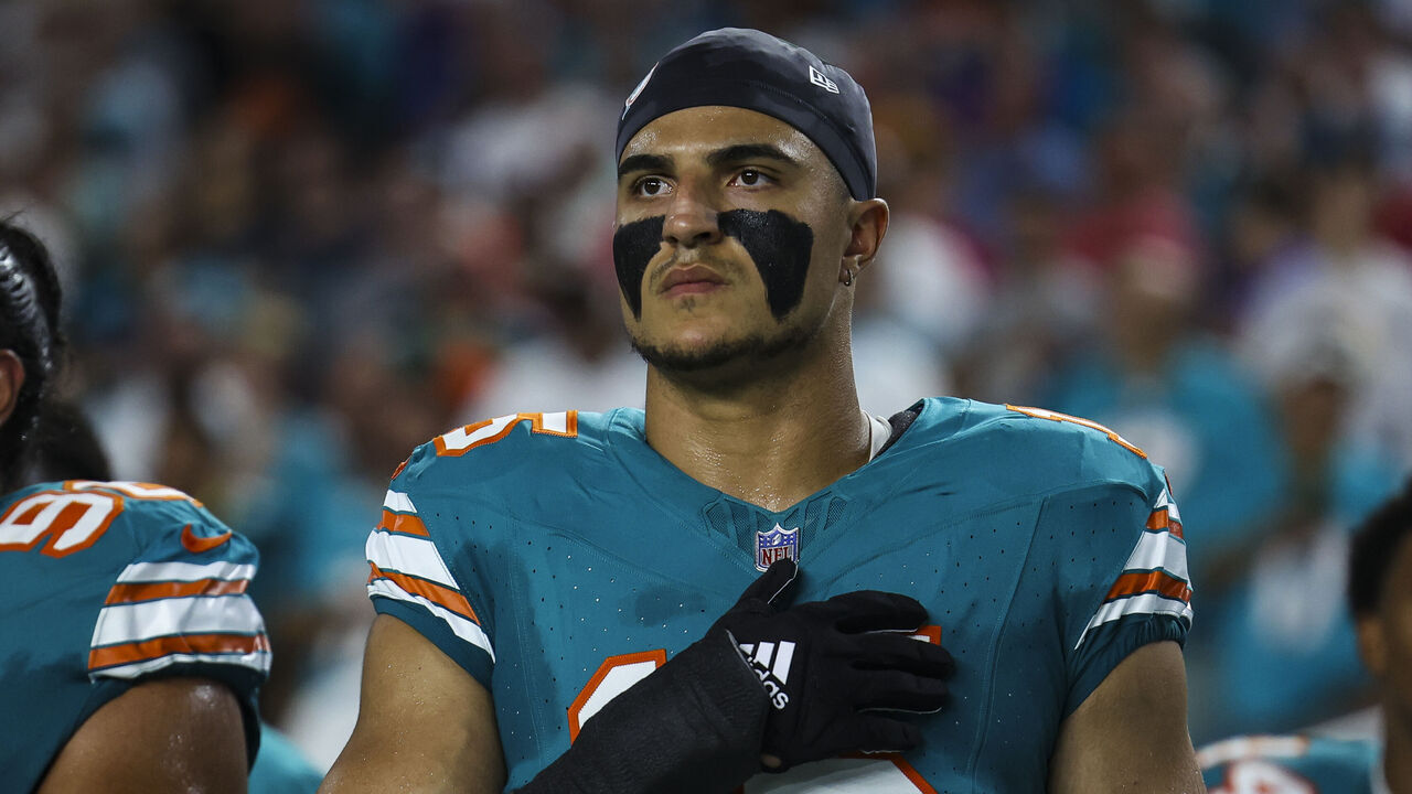MIAMI GARDENS, FL - SEPTEMBER 12: Jaelan Phillips #15 of the Miami Dolphins looks on from the sideline during the national anthem prior to an NFL football game against the Buffalo Bills at Hard Rock Stadium on September 12, 2024 in Miami Gardens, FL.