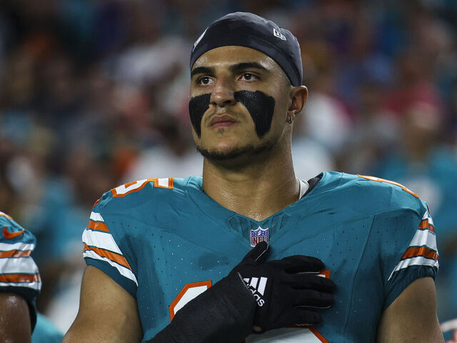 MIAMI GARDENS, FL - SEPTEMBER 12: Jaelan Phillips #15 of the Miami Dolphins looks on from the sideline during the national anthem prior to an NFL football game against the Buffalo Bills at Hard Rock Stadium on September 12, 2024 in Miami Gardens, FL.