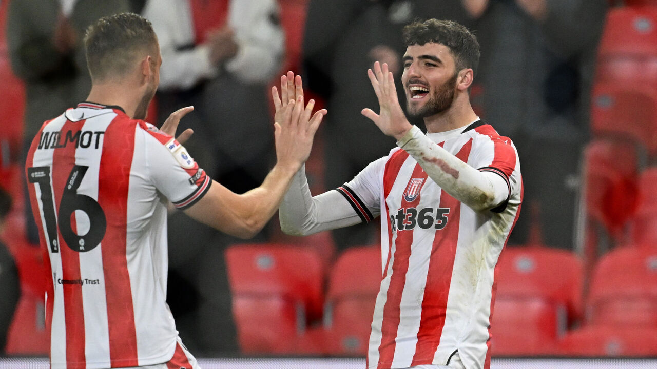 STOKE ON TRENT, ENGLAND - OCTOBER 02: Thomas Cannon of Stoke City celebrates his 4th goal with Ben Wilmot during the Sky Bet Championship match between Stoke City FC and Portsmouth FC at Bet365 Stadium on October 02, 2024 in Stoke on Trent, England.