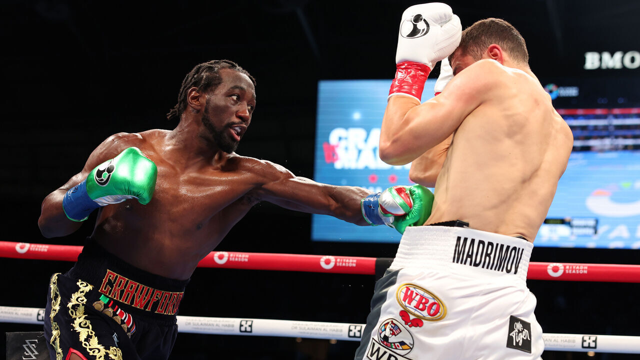 LOS ANGELES, CALIFORNIA - AUGUST 03: Terence Crawford (black and gold shorts) and Israil Madrimov (white shorts) fight during their WBA World Interim WBO World Super Welterweight Title Contest, at BMO Stadium on August 3, 2024 in Los Angeles, California.