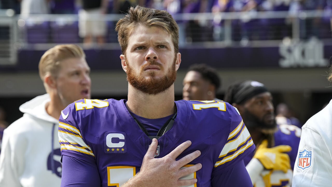 MINNEAPOLIS, MN - SEPTEMBER 22: Quarterback Sam Darnold #14 of the Minnesota Vikings stands on the sidelines during the national anthem prior to an NFL football game against the Houston Texans, at U.S. Bank Stadium on September 22, 2024 in Minneapolis, Minnesota.