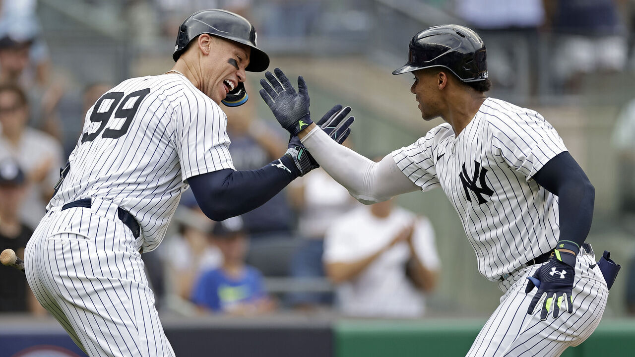 NEW YORK, NY - AUGUST 4: Juan Soto #22 of the New York Yankees reacts with Aaron Judge #99 of the New York Yankees after hitting a home run during the seventh inning against the Toronto Blue Jays at Yankee Stadium on August 4, 2024 in New York City.