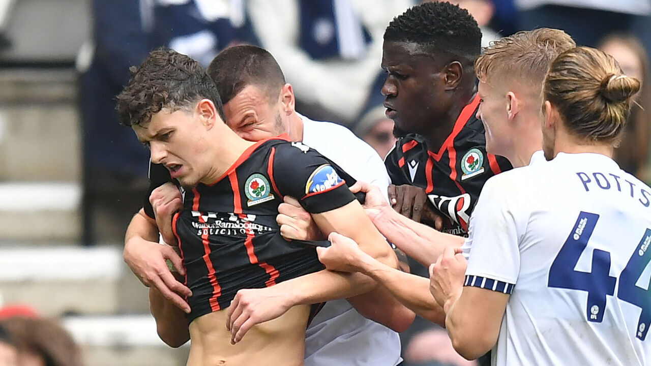 PRESTON, ENGLAND - SEPTEMBER 22: Blackburn Rovers' Owen Beck seems to be bitten on the neck by Preston North End's Milutin Osmajic during the Sky Bet Championship match between Preston North End FC and Blackburn Rovers FC at Deepdale on September 22, 2024 in Preston, England.