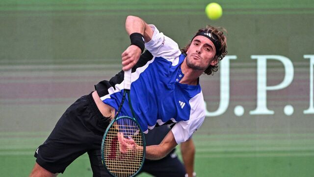 Greece's Stefanos Tsitsipas hits a return to Japan's Kei Nishikori during their men's singles match at the Shanghai Masters tennis tournament in Shanghai on October 4, 2024.