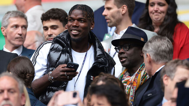DUSSELDORF, GERMANY - JULY 01: Former France, Manchester United and Juventus midfielder Paul Pogba reacts with former France, Juventus and Barceloona defender Lilian Thuram ( also the father of Marcus Thuram of France ) in the tribune prior to during the UEFA EURO 2024 round of 16 match between France and Belgium at Düsseldorf Arena on July 01, 2024 in Dusseldorf, Germany.
