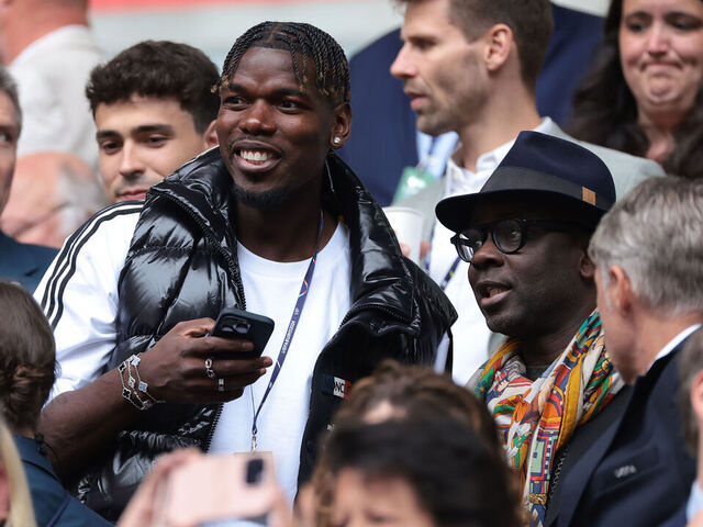 DUSSELDORF, GERMANY - JULY 01: Former France, Manchester United and Juventus midfielder Paul Pogba reacts with former France, Juventus and Barceloona defender Lilian Thuram ( also the father of Marcus Thuram of France ) in the tribune prior to during the UEFA EURO 2024 round of 16 match between France and Belgium at Düsseldorf Arena on July 01, 2024 in Dusseldorf, Germany.
