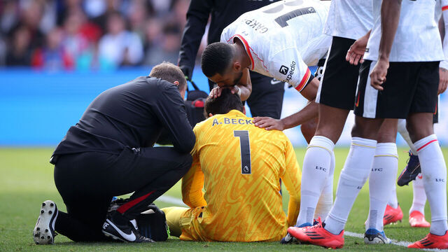 LONDON, ENGLAND - OCTOBER 05: Alisson Becker of Liverpool is comforted by teammate Cody Gakpo as he receives medical treatment after an injury during the Premier League match between Crystal Palace FC and Liverpool FC at Selhurst Park on October 05, 2024 in London, England.