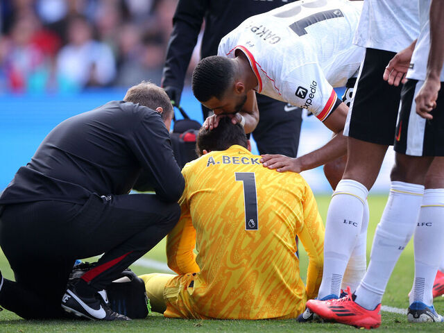 LONDON, ENGLAND - OCTOBER 05: Alisson Becker of Liverpool is comforted by teammate Cody Gakpo as he receives medical treatment after an injury during the Premier League match between Crystal Palace FC and Liverpool FC at Selhurst Park on October 05, 2024 in London, England.