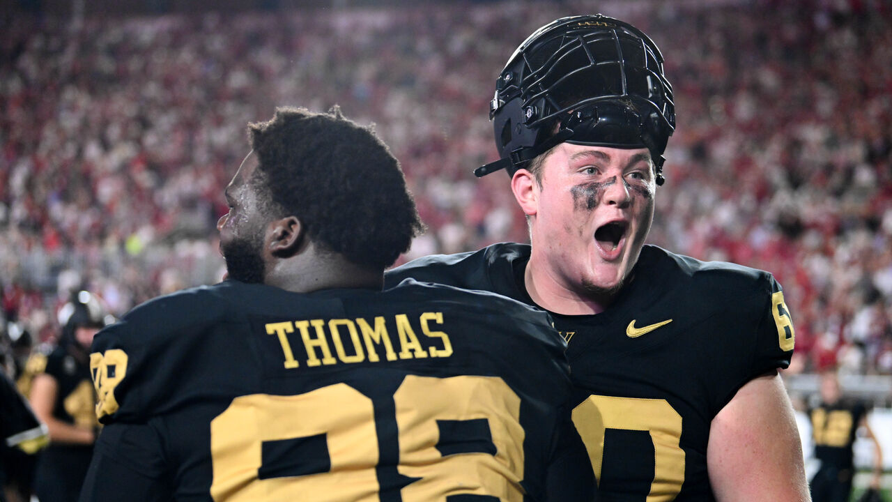 NASHVILLE, TENNESSEE - OCTOBER 5: Duncan MacDonald #60 and De'Marion Thomas #98 of the Vanderbilt Commodores celebrate their win against the Alabama Crimson Tide at FirstBank Stadium on October 5, 2024 in Nashville, Tennessee.