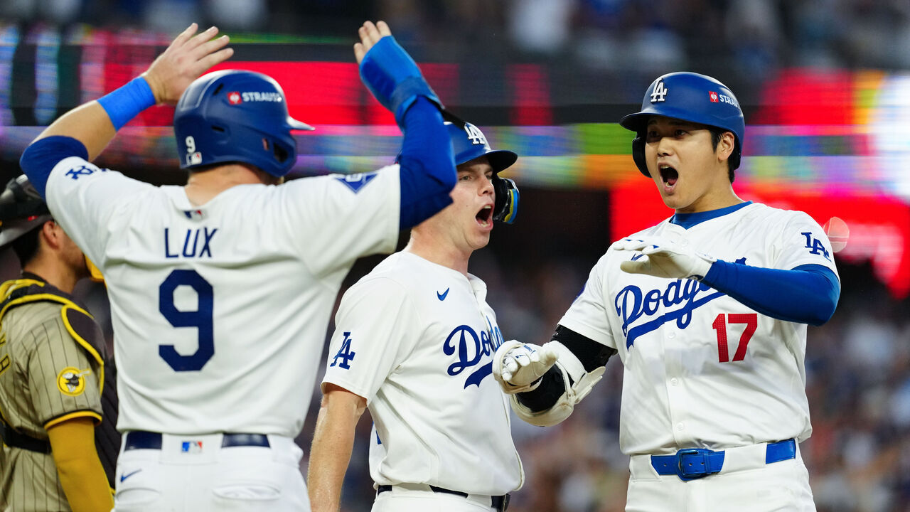 LOS ANGELES, CA - OCTOBER 05: Shohei Ohtani #17 of the Los Angeles Dodgers celebrates with Will Smith #16 and Gavin Lux #9 after hitting a three-run home run in the second inning during Game 1 of the Division Series presented by Booking.com between the San Diego Padres and the Los Angeles Dodgers at Dodger Stadium on Saturday, October 5, 2024 in Los Angeles, California.