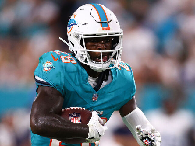 MIAMI GARDENS, FLORIDA - SEPTEMBER 30: De'Von Achane #28 of the Miami Dolphins carries the ball against the Tennessee Titans during the first half at Hard Rock Stadium on September 30, 2024 in Miami Gardens, Florida.