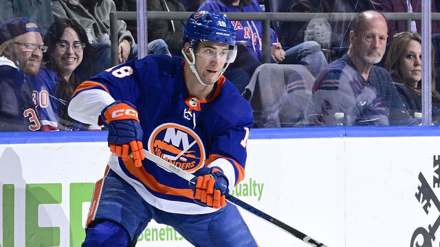 ELMONT, NEW YORK - APRIL 09: Pierre Engvall #18 of the New York Islanders passes the puck against the New York Rangers at UBS Arena on April 09, 2024 in Elmont, New York.