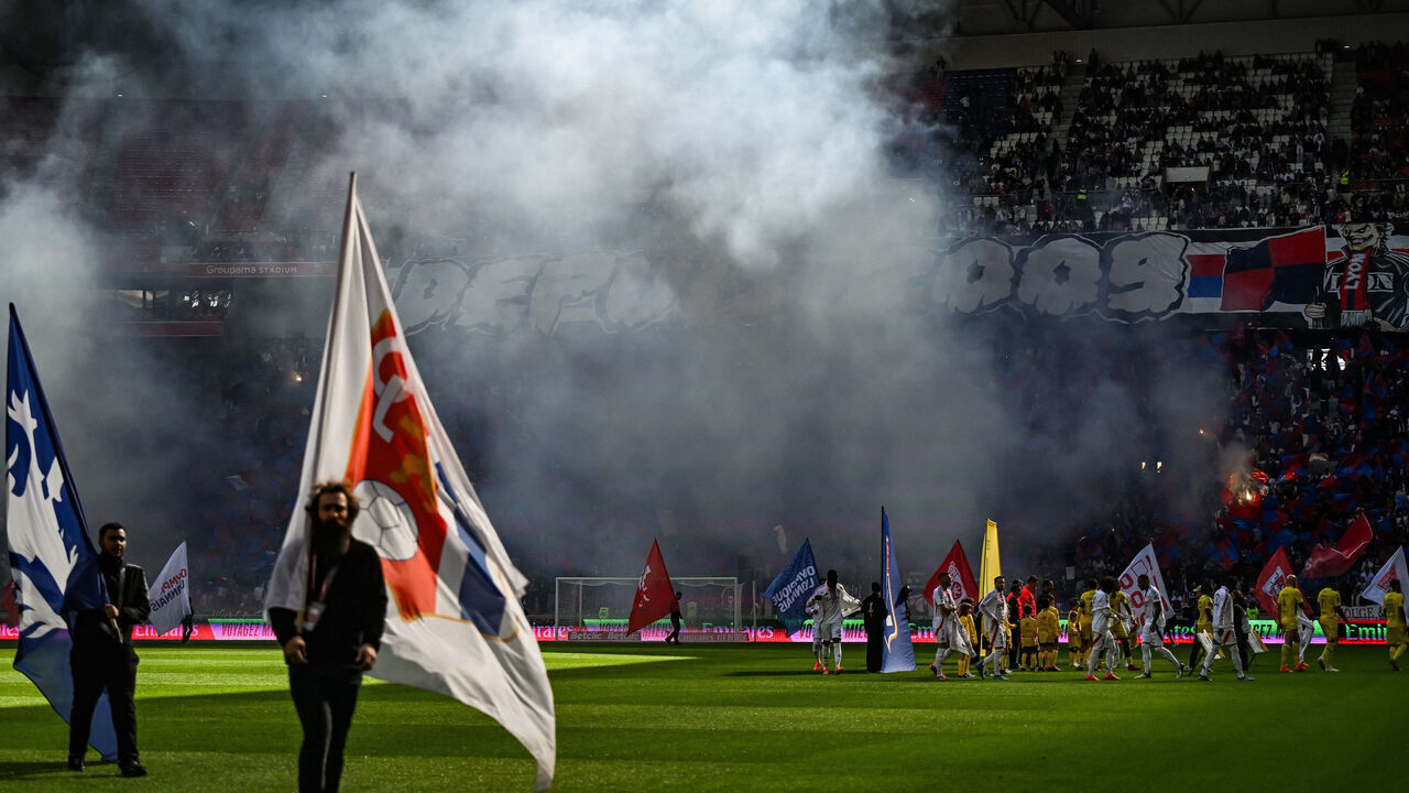 Lyon' supporters light flares before the French L1 football match between Lyon (OL) and Nantes (FCNA) at the Groupama stadium in Decines-Charpieu, on October 6, 2024.