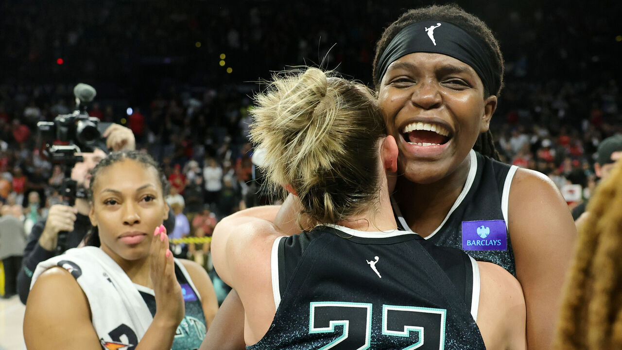 LAS VEGAS, NEVADA - OCTOBER 06: Betnijah Laney-Hamilton #44, Courtney Vandersloot #22 and Jonquel Jones #35 of the New York Liberty celebrate on the court after defeating the Las Vegas Aces 76-62 in Game Four of the 2024 WNBA Playoffs semifinals to win the series three games to one at Michelob ULTRA Arena on October 06, 2024 in Las Vegas, Nevada.