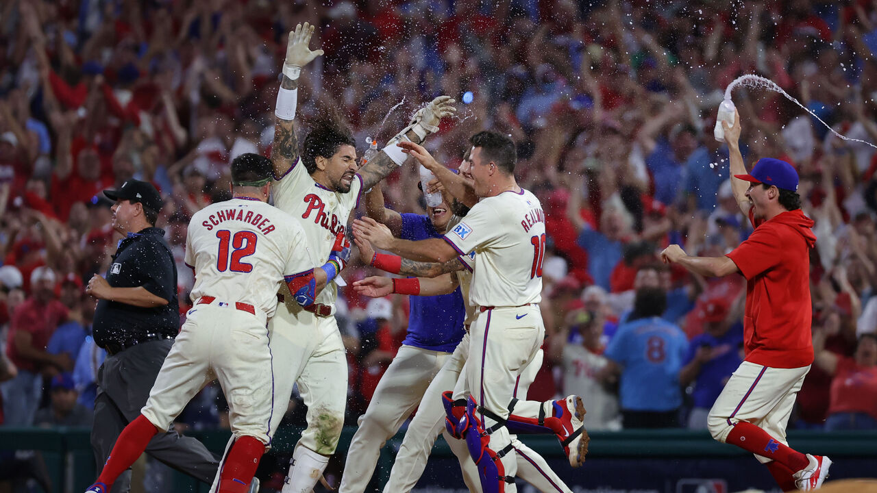 PHILADELPHIA, PENNSYLVANIA - OCTOBER 06: Nick Castellanos #8 of the Philadelphia Phillies celebrates with teammates after the game-winning hit to defeat the New York Mets in Game Two of the Division Series at Citizens Bank Park on October 06, 2024 in Philadelphia, Pennsylvania.