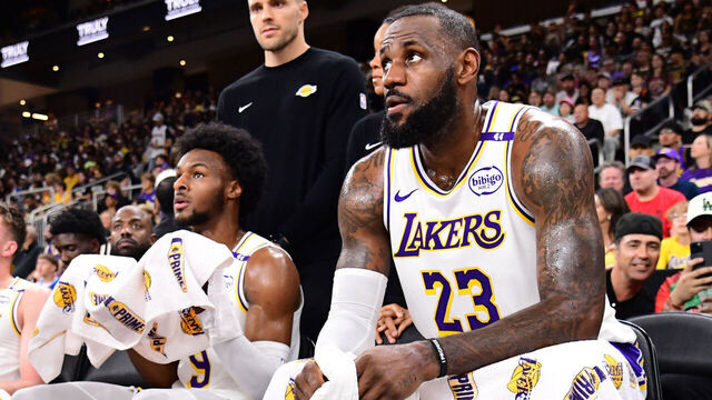 LOS ANGELES, CA - OCTOBER 6: LeBron James #23 and Bronny James #9 of the Los Angeles Lakers look on during the game against the Phoenix Suns on October 6, 2024 at Acrisure Arena in Palm Springs, California. NOTE TO USER: User expressly acknowledges and agrees that, by downloading and/or using this Photograph, user is consenting to the terms and conditions of the Getty Images License Agreement. Mandatory Copyright Notice: Copyright 2024 NBAE