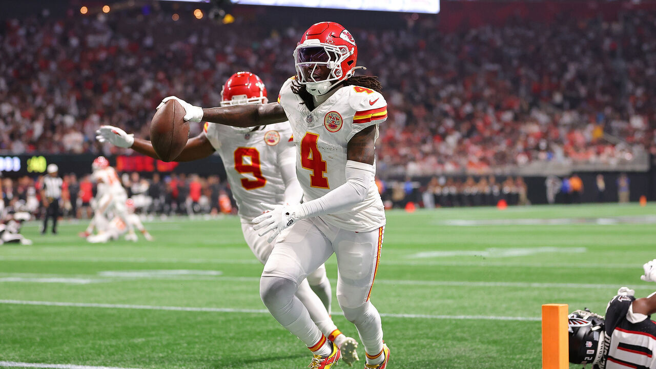 ATLANTA, GEORGIA - SEPTEMBER 22: Rashee Rice #4 of the Kansas City Chiefs scores a touchdown while defended by Dee Alford #20 of the Atlanta Falcons during the second quarter at Mercedes-Benz Stadium on September 22, 2024 in Atlanta, Georgia.