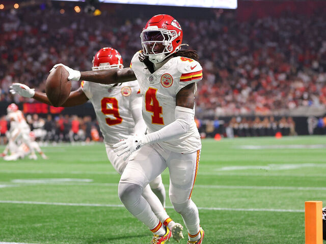 ATLANTA, GEORGIA - SEPTEMBER 22: Rashee Rice #4 of the Kansas City Chiefs scores a touchdown while defended by Dee Alford #20 of the Atlanta Falcons during the second quarter at Mercedes-Benz Stadium on September 22, 2024 in Atlanta, Georgia.