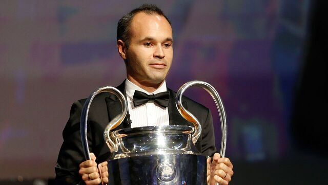 FC Barcelona's captain Andres Iniesta holds the Champions League trophy at the start of the UEFA Champions League Group stage draw ceremony, on August 27, 2015 in Monaco. AFP PHOTO / VALERY HACHE