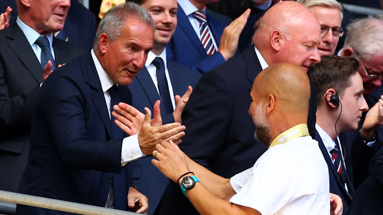 LONDON, ENGLAND - AUGUST 10: Manchester City manager Josep Guardiola shakes hands with director of football Aitor "Txiki" Begiristain following the 2024 FA Community Shield match between Manchester United and Manchester City at Wembley Stadium on August 10, 2024 in London, England.