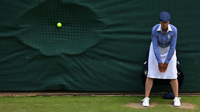 TOPSHOT - A line judge stands in position as a ball hits the back netting after a serve during the men's doubles semi-final tennis match between Britain's Henry Patten and Finland's Harri Heliövaara, and New Zealand's Michael Venus and Britain's Neal Skupski, on the eleventh day of the 2024 Wimbledon Championships at The All England Lawn Tennis and Croquet Club in Wimbledon, southwest London, on July 11, 2024.