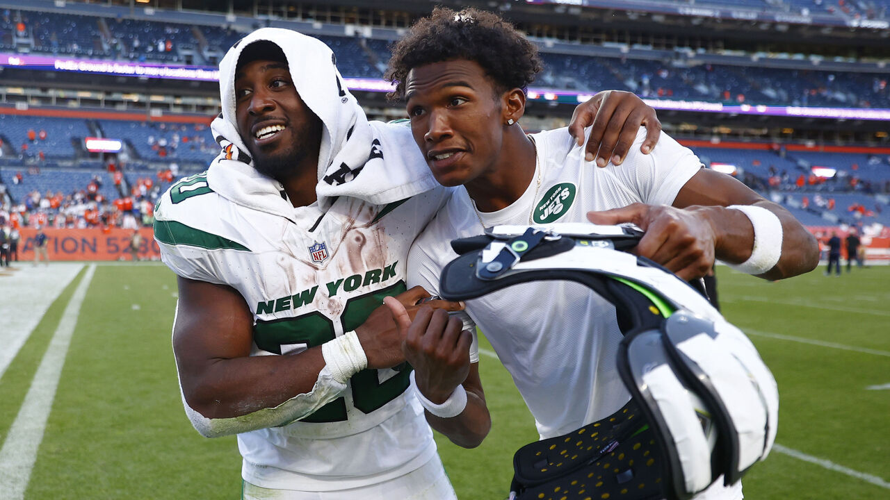 DENVER, COLORADO - OCTOBER 08: Breece Hall #20 and Garrett Wilson #17 of the New York Jets celebrate after beating the Denver Broncos 31-21 at Empower Field At Mile High on October 08, 2023 in Denver, Colorado.