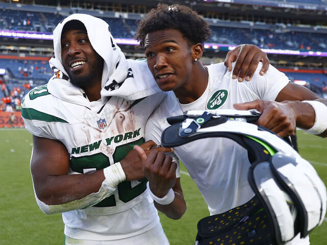 DENVER, COLORADO - OCTOBER 08: Breece Hall #20 and Garrett Wilson #17 of the New York Jets celebrate after beating the Denver Broncos 31-21 at Empower Field At Mile High on October 08, 2023 in Denver, Colorado.