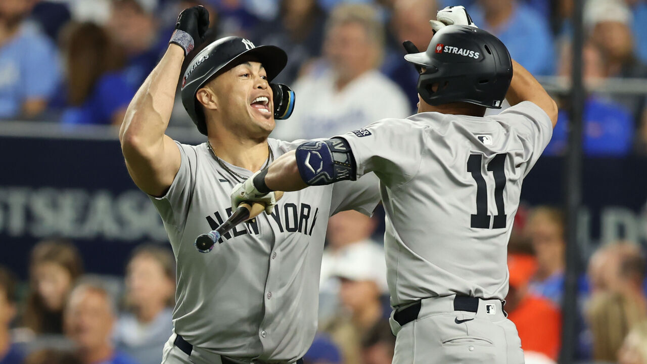 KANSAS CITY, MO - OCTOBER 09: New York Yankees designated hitter Giancarlo Stanton (27) celebrates with shortstop Anthony Volpe (11) after hitting a go-ahead home run in the eighth inning of game 3 of the ALDS between the New York Yankees and Kansas City Royals on October 9, 2024 at Kauffman Stadium in Kansas City, MO.