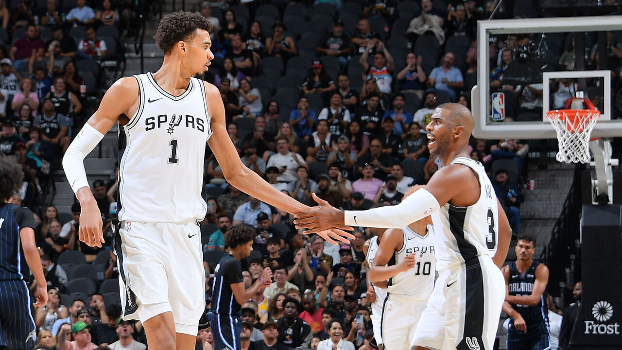SAN ANTONIO, TX - OCTOBER 9: Victor Wembanyama #1 and Chris Paul #3 of the San Antonio Spurs high five during the game against the Orlando Magic during a NBA preseason game on October 9, 2024 at the Frost Bank Center in San Antonio, Texas. Mandatory Copyright Notice: Copyright 2024 NBAE (Photos by Michael Gonzales/NBAE via Getty Images)