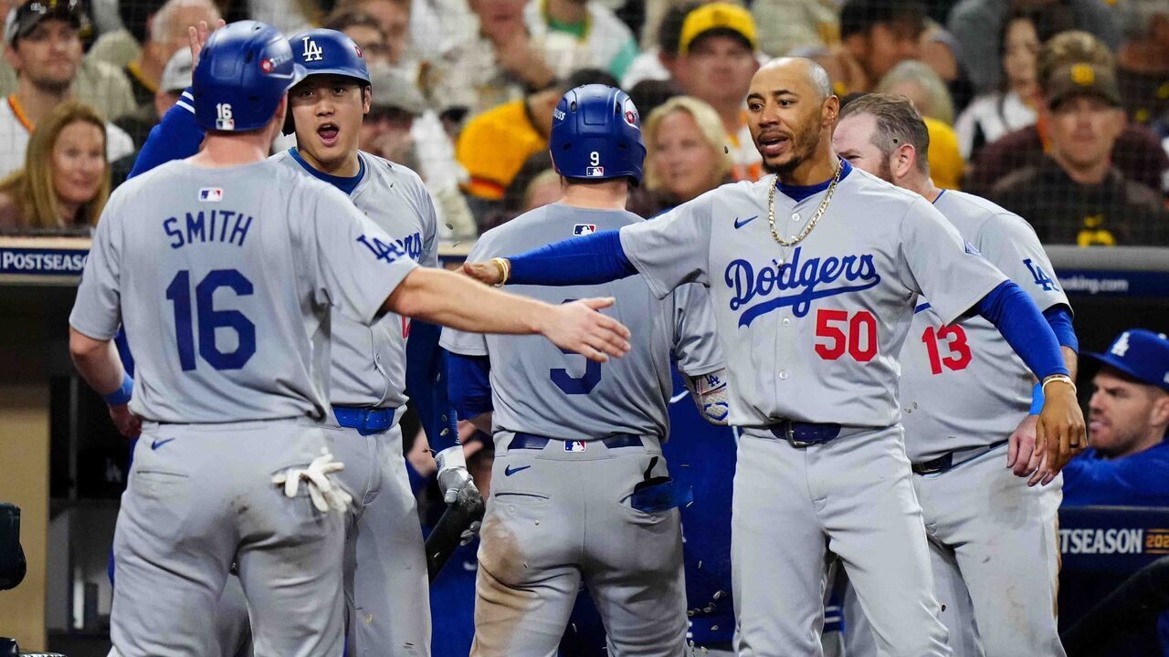 SAN DIEGO, CA - OCTOBER 09: Will Smith #16 of the Los Angeles Dodgers celebrates with Shohei Ohtani #17 and Mookie Betts #50 after scoring in the seventh inning during Game 4 of the Division Series presented by Booking.com between the Los Angeles Dodgers and the San Diego Padres at Petco Park on Wednesday, October 9, 2024 in San Diego, California.