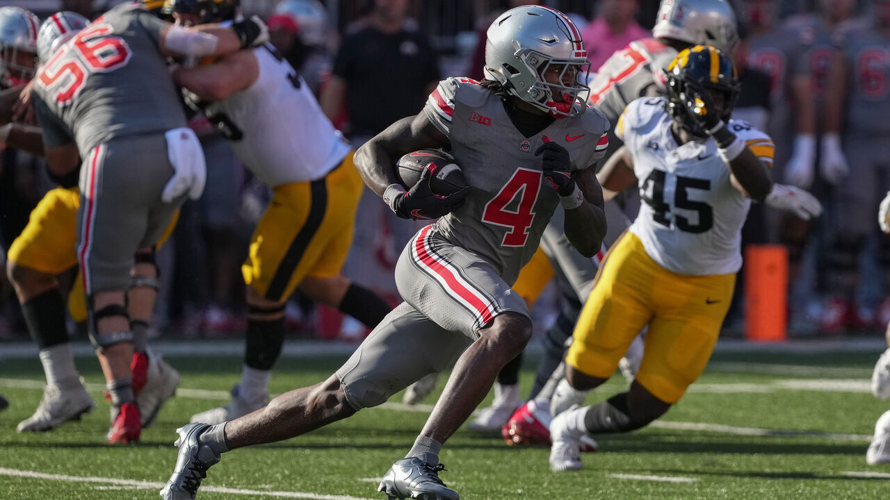 COLUMBUS, OHIO - OCTOBER 05: Wide receiver Jeremiah Smith #4 of the Ohio State Buckeyes carries the ball against the Iowa Hawkeyes during the second quarter at Ohio Stadium on October 05, 2024 in Columbus, Ohio.