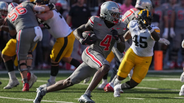 COLUMBUS, OHIO - OCTOBER 05: Wide receiver Jeremiah Smith #4 of the Ohio State Buckeyes carries the ball against the Iowa Hawkeyes during the second quarter at Ohio Stadium on October 05, 2024 in Columbus, Ohio.