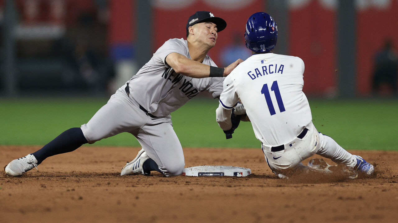 KANSAS CITY, MISSOURI - OCTOBER 10: Anthony Volpe #11 of the New York Yankees tags out Maikel Garcia #11 of the Kansas City Royals during the sixth inning during Game Four of the Division Series at Kauffman Stadium on October 10, 2024 in Kansas City, Missouri.
