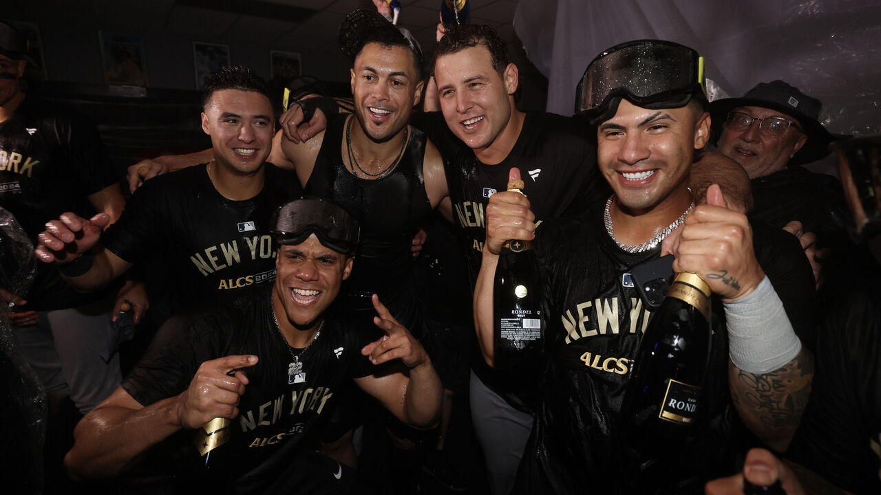 KANSAS CITY, MISSOURI - OCTOBER 10: The New York Yankees celebrate in the locker room after a win over the Kansas City Royals in Game Four of the Division Series at Kauffman Stadium on October 10, 2024 in Kansas City, Missouri.